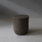 Remi Side Table in Pebble micro cement finish, highlighting its round shape and smooth texture.